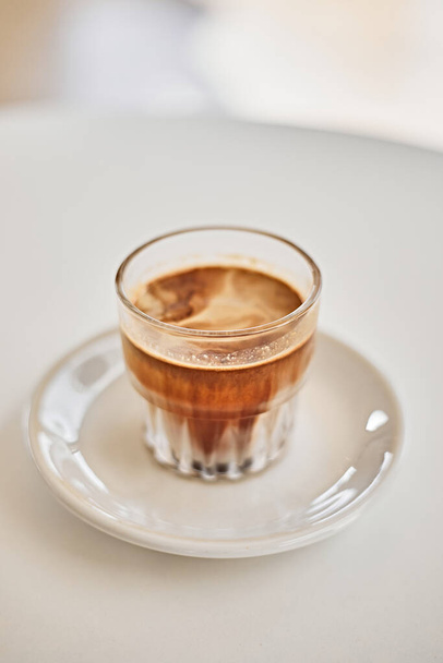 Dirty coffee,Cold milk topped with hot espresso shot - Фото, зображення