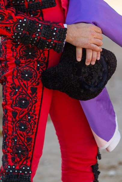 typical bullfighter costume in a bullfight. One hand hold the typical hat - Photo, Image