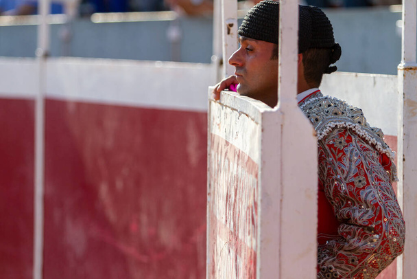 close up of a concentrated bullfighter watches the bullfight from the sidelines - Photo, Image