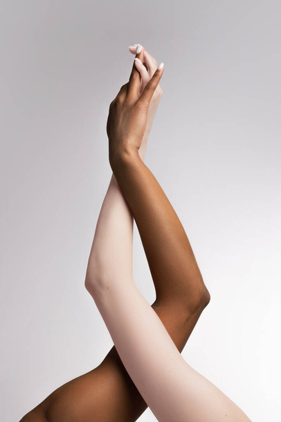 Support. Plexus of female hands. Graceful female hands touch each other isolated on grey studio background. Concept of diversity, unity, love, support. Human rights, choice and equality - Fotó, kép