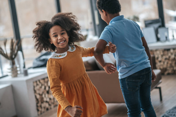 Dancing kids. A boy and a girl dancing and looking joyful - Fotografie, Obrázek
