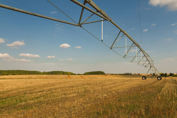 Structure irrigation system self-propelled mobile Spray (pivot) in harvested grain field  - Photo, Image