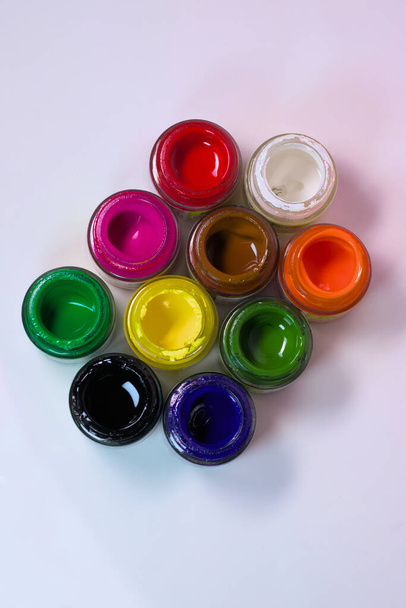 Vibrant fabric color bottles with open lids - 写真・画像