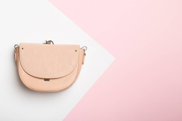 Fashionable woman bag on color background. Top view. - 写真・画像