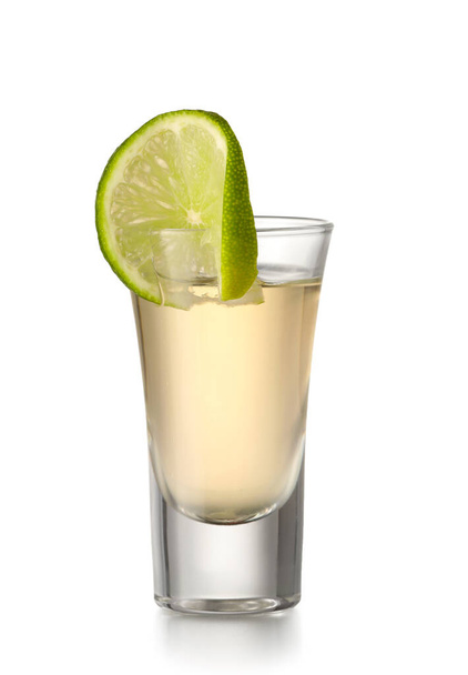 Shot of tasty mexican tequila with lime on white background - Foto, imagen
