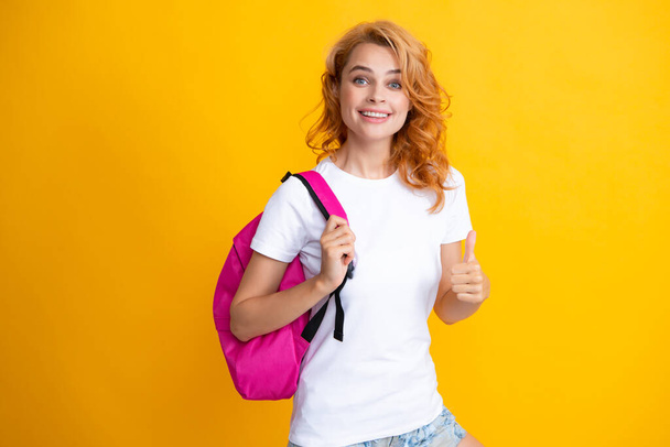 Surprised fun teen student girl with backpack on pastel yellow color background. Education in university college concept - Photo, image