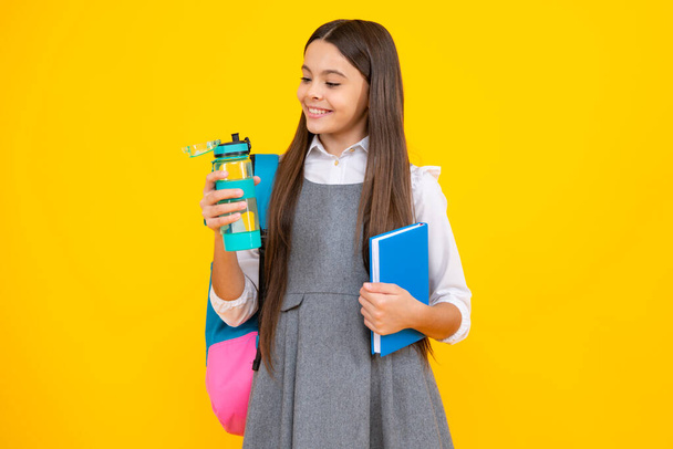 Teenager school girl with backpack holding water bottle - Photo, Image
