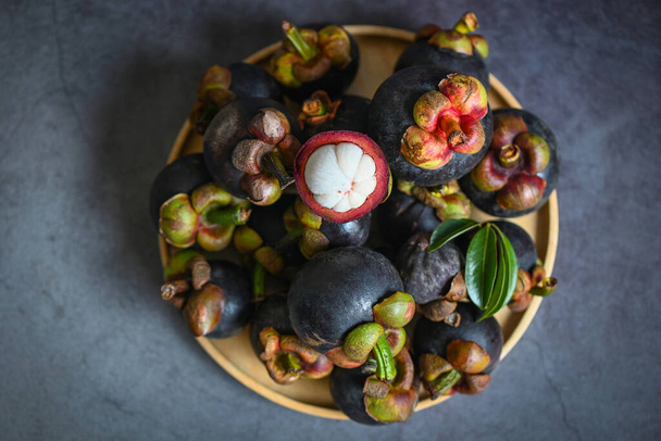 Mangosteen on plate and dark background, fresh ripe mangosteen peeled from tree at tropical fruit Thailand in summer - 写真・画像