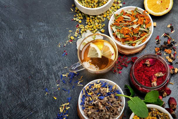 Herbal tea assortment on dark background. Traditional healthcare remedies. Top view, flat lay, copy space - Photo, Image