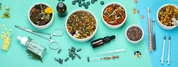 Assortment of herbal and traditional medicine on colourful background. Traditional healthcare concept. Natural homoeopathic remedies. Top view, flat lay, panorama - Фото, зображення