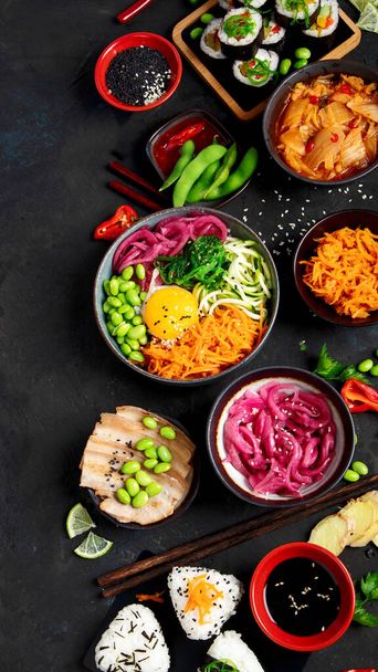 Assortment of Korean food on dark background. Asian dishes and appetizers of indeed cuisine. Top view, flat lay, copy space - Photo, Image