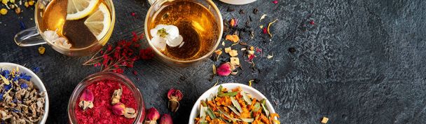 Herbal tea assortment on dark background. Traditional healthcare remedies. Top view, flat lay, copy space, panorama - Foto, imagen
