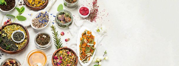 Herbal tea assortment on light background. Traditional healthcare remedies. Top view, flat lay, copy space, panorama - Foto, Bild