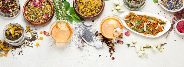 Herbal tea assortment on light background. Traditional healthcare remedies. Top view, flat lay, copy space, panorama - Foto, afbeelding