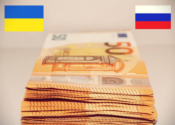 Stack of European money between Ukraine and Russia . - Photo, Image