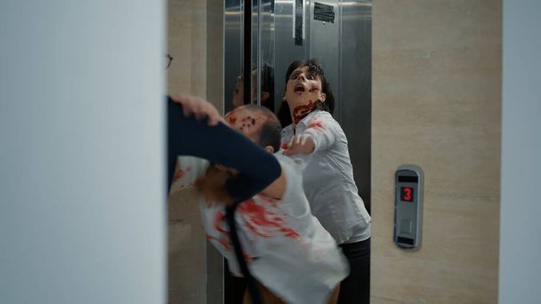 Biznesmen opuszcza biuro, ale zaczyna biec, gdy przerażające zombie zjadające mózg wychodzą z windy. Człowiek idący do domu, ale przerażająco wyglądające potwory wchodzą mu w drogę i ścigają go na dole.. - Zdjęcie, obraz