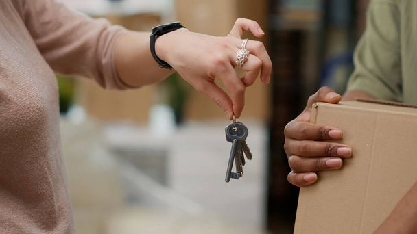 Married couple buying first home and having house keys, moving in real estate property together. Celebrating relationship event and household relocation bought on mortgage. Close up. - Zdjęcie, obraz