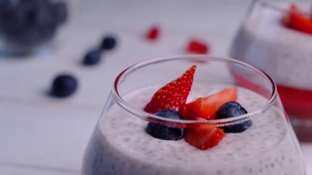 dessert with berries. Chia seed pudding with berries in a jar on a wooden table. Vegetarian concept. Dessert delicious healthy breakfast. High quality 4k footage - Footage, Video