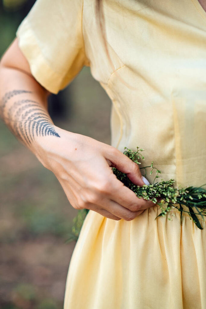 Midsummer solstice ritual. Celebrating summer solstice. Significance of the solstice in Paganism. Woman with herbs wreath on nature background. - Fotografie, Obrázek