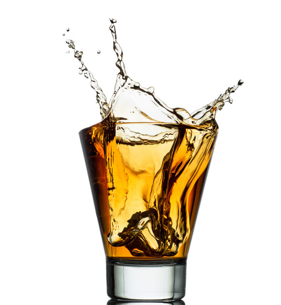 Isolated shots of whiskey with splash on white - 写真・画像