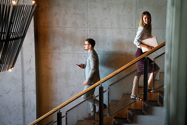 Young coworker business people climb the stairs in the office building - 写真・画像