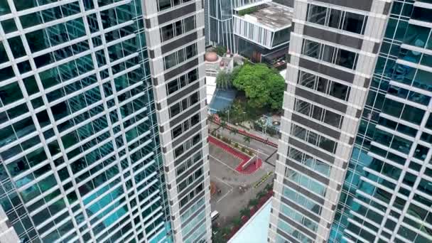 Volando entre dos rascacielos altos modernos con oficinas y apartamentos de lujo. Cámara arreglada. Ciudad del centro. Vista aérea. - Metraje, vídeo