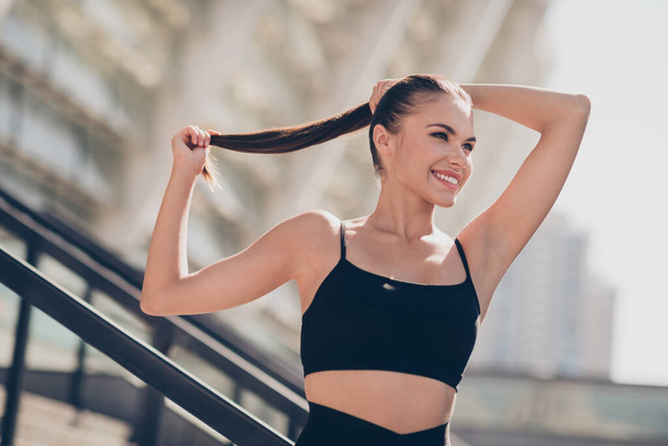 Photo of sporty dynamic positive lady ready for morning outdoors warm up aerobics endurance fix ponytail. - Foto, Imagen