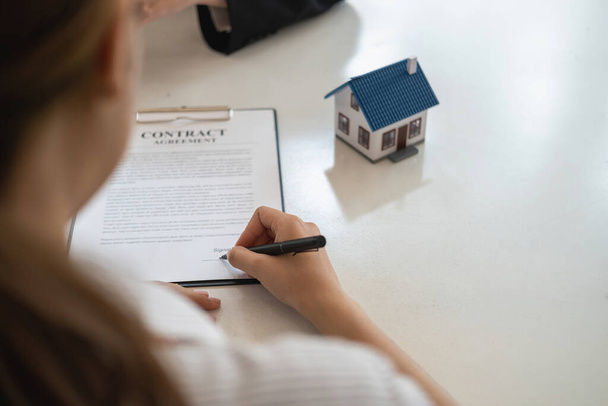 Buying houses and land, guarantees, contract and agreement, An employee of a real estate company hands over the house and keys after the contract for the sale of land and buildings is complete. - Photo, Image
