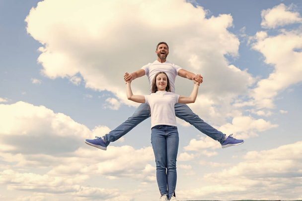happy father and daughter jumping in sky. - Foto, Imagen