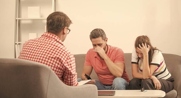 sad couple at psychologist session. family therapy. man and woman talk to social worker. interpersonal relations. life coach. visiting sexologist. lawyer helps with marriage contract. misunderstanding - Photo, image