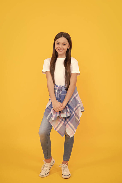 hipster child smile in casual clothes full length on yellow background. - Foto, Imagen