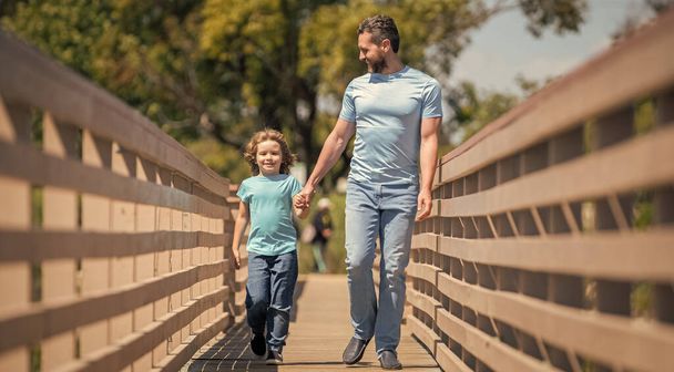 fathers day. cheerful father leading son outdoor. family value. childhood and parenthood. parent relax with little child boy. dad with kid on summer day. parenting and fatherhood. - Photo, Image