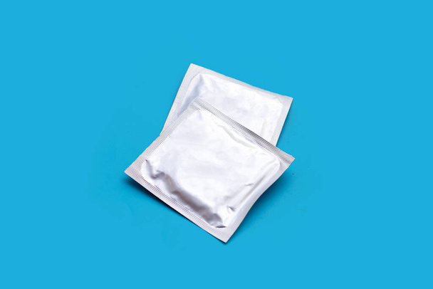 Condom on blue background. Copy space - Fotografie, Obrázek