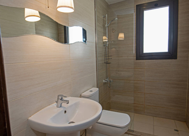 Diseño interior de un lujoso cuarto de baño con cabina de ducha inodoro y lavabo - Foto, imagen