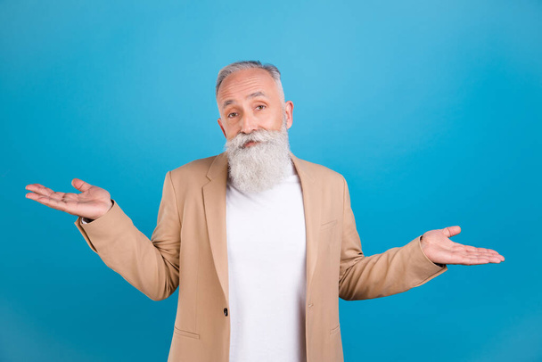 Portrait of attractive puzzled classy grey-haired man shrugging shoulders no answer isolated over bright blue color background. - Фото, зображення
