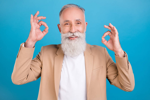 Portrait of attractive cheerful grey-haired man showing double ok-sign ad agree isolated over bright blue color background. - Фото, зображення