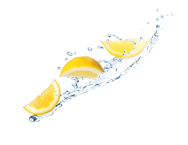 Fresh ripe lemon and splashing water on white background - Фото, изображение