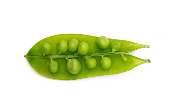 Green peas on a white background, top view. - Valokuva, kuva