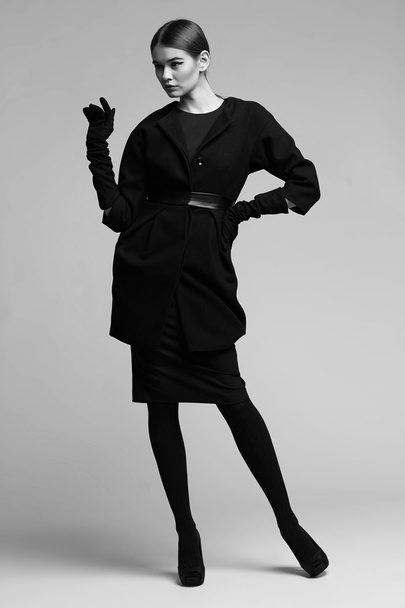 high fashion portrait of elegant woman in black coat. Studio sho - Фото, изображение