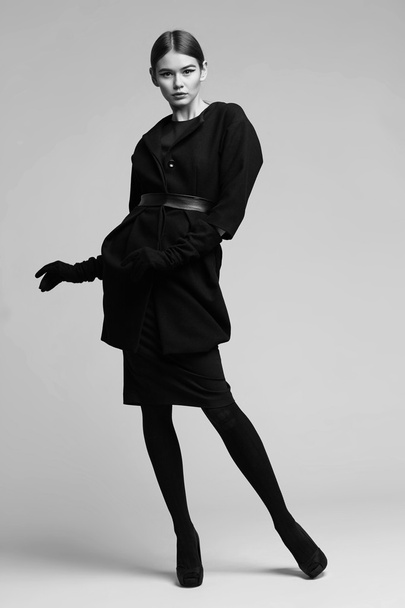 high fashion portrait of elegant woman in black coat. Studio sho - Photo, Image