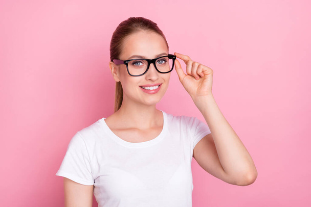 Photo of young woman happy positive smile confident hand touch glasses isolated over pink color background. - 写真・画像