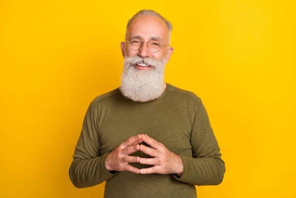 Photo of smart aged white beard man wear eyewear green sweater isolated on yellow color background. - 写真・画像