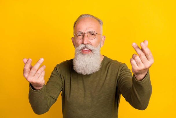 Photo of sad aged grey beard man yell wear eyewear green sweater isolated on yellow color background. - Fotografie, Obrázek