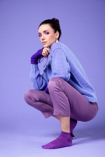 Portrait of lovely girl with violet purple outfit, isolated over violet purple background. Purple violet make-up. - Foto, imagen