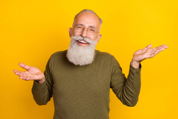 Photo of funny clueless grandpa shrug shoulders wear glasses green shirt isolated yellow color background. - Foto, Imagem