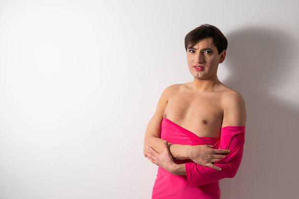Homosexual in a pink female dress. A man in make-up - Фото, зображення