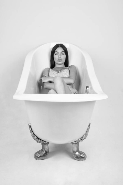 sexy woman with long hair and makeup relax in bathtub, fashion. - Фото, зображення