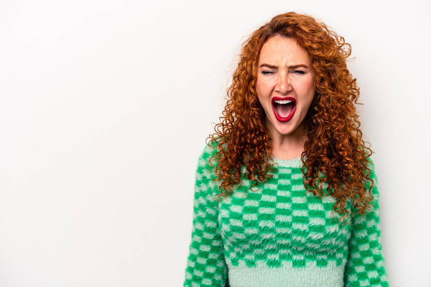 Young ginger caucasian woman isolated on white background shouting very angry, rage concept, frustrated. - Φωτογραφία, εικόνα