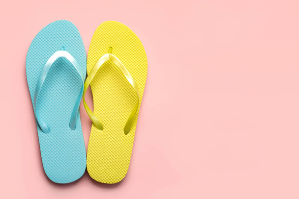 Summer holiday concept.Top view of colored beach flip flops with space for text over pink background - Valokuva, kuva
