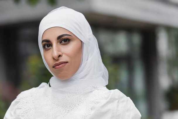 portrait of muslim woman in white wedding hijab looking at camera - Photo, Image